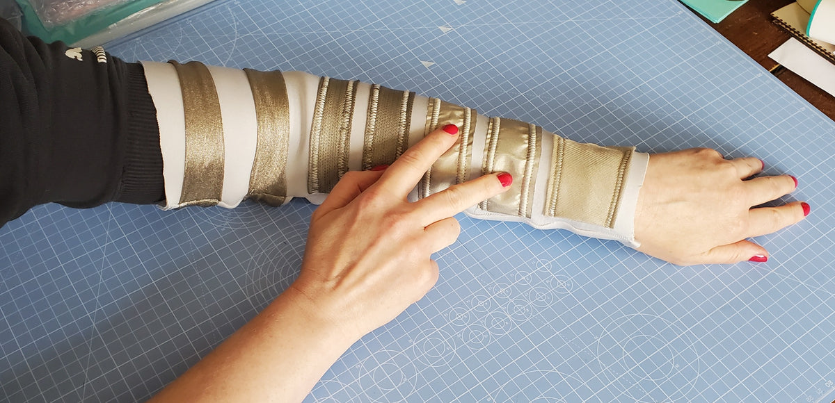 Arm sleeve with conductive fabric strips, a wearable project example