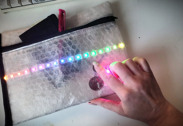 Gemma microcontroller board sewn into wearable tech project