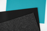 Three sheets of different colored felt fabric on a white background