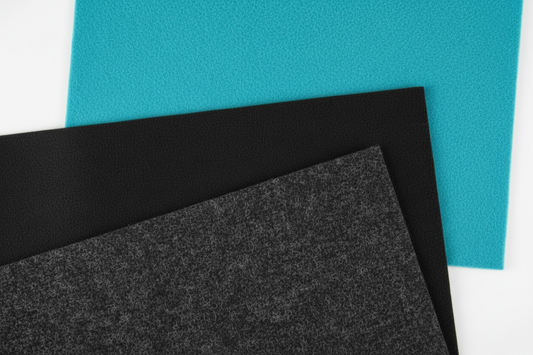 Three sheets of different colored felt fabric on a white background