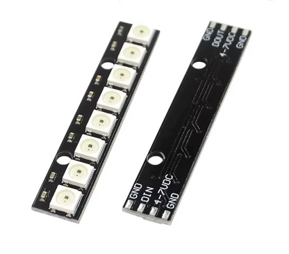 Two black PCB module strips with multiple white cylindrical components and printed terminal labels, shown on a plain white background. 