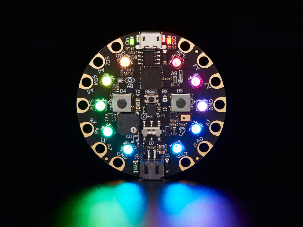 Round electronic circuit board with colorful LEDs on a black background