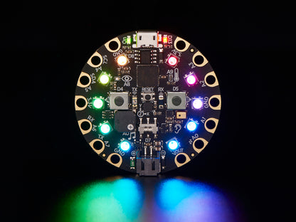 Round electronic circuit board with colorful LEDs on a black background