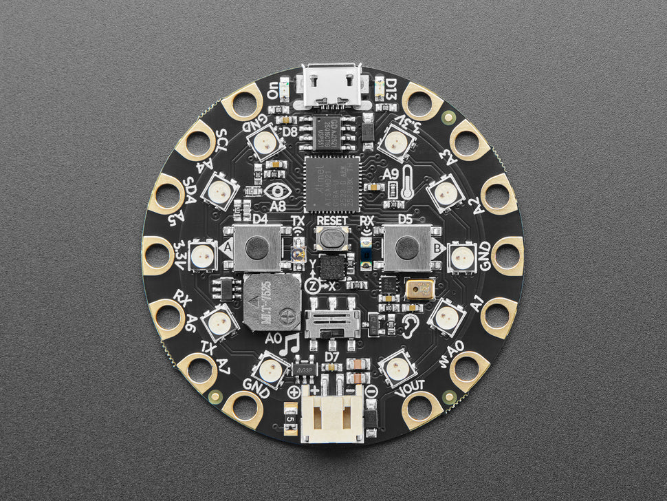 Circular electronic circuit board with various components on a gray background