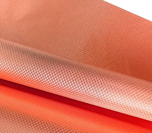 Close-up of gold copper diamond grid conductive fabric showing the grid weave