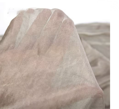 Hand holding sheer silver tulle mesh conductive fabric